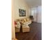 Cozy living room featuring a floral sofa set, hardwood floors, and plantation shutters for comfortable living at 3394 Brookfield Dr, Las Vegas, NV 89120