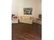 Living room featuring wood floors, stylish sofa, and bright lighting at 3394 Brookfield Dr, Las Vegas, NV 89120
