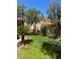 A lush green side yard, full of trees, offers a private outdoor space at 3394 Brookfield Dr, Las Vegas, NV 89120