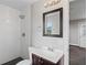 Updated bathroom with modern fixtures, white tile shower, and a decorative mirror at 3412 Tabor Ave, North Las Vegas, NV 89030