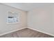 Neutrally painted bedroom with plush carpet and natural light from the window at 3412 Tabor Ave, North Las Vegas, NV 89030