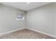 Light-filled bedroom with neutral carpet and a large window at 3412 Tabor Ave, North Las Vegas, NV 89030