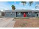 Charming single-story home with a red front door, offering a welcoming curb appeal at 3412 Tabor Ave, North Las Vegas, NV 89030
