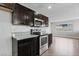 Well-equipped kitchen with sleek dark cabinetry, granite countertops, and modern appliances at 3412 Tabor Ave, North Las Vegas, NV 89030