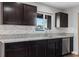 Kitchen close-up with dark cabinets, granite counters, stainless steel appliances at 3412 Tabor Ave, North Las Vegas, NV 89030