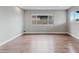 Open floor plan living room with modern flooring and natural light from the window at 3412 Tabor Ave, North Las Vegas, NV 89030