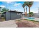A backyard pool is surrounded by palm trees and a white fence creating a private oasis at 3412 Tabor Ave, North Las Vegas, NV 89030