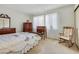 Bedroom featuring a large window, a comfortable rocking chair, and ample storage at 3553 Kensbrook St, Las Vegas, NV 89121