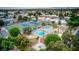 Aerial view of community amenities featuring a pool, spa, and tennis courts surrounded by mature landscaping at 3553 Kensbrook St, Las Vegas, NV 89121