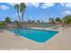 Community pool with clear blue water, lounge chairs, and well-maintained surroundings for a relaxing experience at 3553 Kensbrook St, Las Vegas, NV 89121