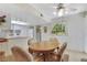 Cozy dining area adjacent to kitchen with a round wooden table, comfortable seating, and bright overhead lighting at 3553 Kensbrook St, Las Vegas, NV 89121