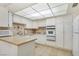 Bright kitchen featuring tile floors, stainless steel appliances, and ample cabinet space at 3553 Kensbrook St, Las Vegas, NV 89121