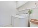 Bright laundry room equipped with a modern washer and dryer and plenty of shelving at 3553 Kensbrook St, Las Vegas, NV 89121