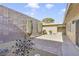 This private patio area with landscaping and unique backyard art piece offers a serene retreat at 3553 Kensbrook St, Las Vegas, NV 89121
