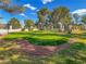 Beautiful putting green area with artificial grass surrounded by green trees and a rock bed at 3553 Kensbrook St, Las Vegas, NV 89121