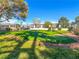 A picturesque putting green is surrounded by trees and desert landscaping at 3553 Kensbrook St, Las Vegas, NV 89121