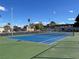 Beautifully maintained blue and green tennis court surrounded by tall palm trees at 3553 Kensbrook St, Las Vegas, NV 89121