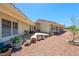 Spacious backyard featuring a covered patio and a row of potted plants at 3640 E Vineyard Dr, Pahrump, NV 89048