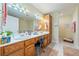 Bright bathroom featuring a double vanity with storage and a large mirror with vanity lighting at 3640 E Vineyard Dr, Pahrump, NV 89048
