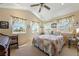 Bedroom with bright natural light, ceiling fan, neutral wall paint, and cozy decor at 3640 E Vineyard Dr, Pahrump, NV 89048