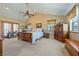 Spacious bedroom featuring a ceiling fan, wooden furnishings, and natural light from windows at 3640 E Vineyard Dr, Pahrump, NV 89048