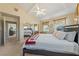 Bedroom boasting a mirrored closet, ceiling fan, and natural light at 3640 E Vineyard Dr, Pahrump, NV 89048