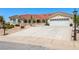 Charming single-story home features a tile roof, two car garage and low-maintenance desert landscaping at 3640 E Vineyard Dr, Pahrump, NV 89048