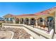 Inviting single-story home with a covered patio and rock landscaping, perfect for desert living at 3640 E Vineyard Dr, Pahrump, NV 89048