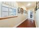 Hallway with wood floors, window with view, and decorated with Gathering photos at 3640 E Vineyard Dr, Pahrump, NV 89048