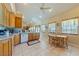 Spacious kitchen with wood cabinets, tile floor, and a breakfast nook with plenty of natural light at 3640 E Vineyard Dr, Pahrump, NV 89048
