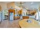 Open concept kitchen with wood cabinets, tile floor, and an eat in area and view to the living room at 3640 E Vineyard Dr, Pahrump, NV 89048