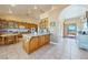 Well lit kitchen featuring wooden cabinetry, tile floor, and an island with countertop seating at 3640 E Vineyard Dr, Pahrump, NV 89048