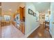 Bright kitchen with wood cabinets, tile floor, and a view into a hallway with wood flooring at 3640 E Vineyard Dr, Pahrump, NV 89048