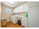 Convenient laundry room with washer, dryer, utility sink, and storage cabinets at 3640 E Vineyard Dr, Pahrump, NV 89048