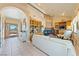Open-concept living room with fireplace, custom wood built-ins and arched doorway at 3640 E Vineyard Dr, Pahrump, NV 89048