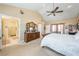 Bright and airy main bedroom featuring a bed, dresser, and access to the en suite bathroom at 3640 E Vineyard Dr, Pahrump, NV 89048
