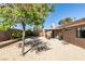 Backyard featuring mature trees, covered patio, and gravel landscaping at 368 Umbria Way, Henderson, NV 89014