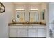 Bathroom featuring dual sinks, two mirrors, vanity, and updated lighting at 368 Umbria Way, Henderson, NV 89014