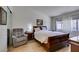 Relaxing bedroom with hardwood floors, a recliner, windows, and natural lighting at 368 Umbria Way, Henderson, NV 89014