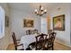 A formal dining room featuring wood floors and a traditional chandelier and traditional wooden table at 368 Umbria Way, Henderson, NV 89014