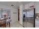 Bright kitchen nook with tile floors, table with chairs and a stainless steel refrigerator at 368 Umbria Way, Henderson, NV 89014