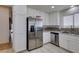 Well-lit kitchen featuring stainless steel appliances, ample white cabinetry, and stylish backsplash detail at 368 Umbria Way, Henderson, NV 89014