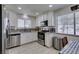 Updated kitchen with stainless steel appliances, a mosaic backsplash and wood look tile flooring at 368 Umbria Way, Henderson, NV 89014