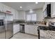 Updated kitchen featuring stainless steel appliances, granite countertops, and tile floors at 368 Umbria Way, Henderson, NV 89014