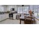Charming kitchen with stainless appliances, mosaic backsplash, and eat in dining area with lots of natural light at 368 Umbria Way, Henderson, NV 89014