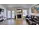 Living room with wood floors, fireplace, and french doors to the backyard at 368 Umbria Way, Henderson, NV 89014