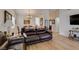 Open living room with hardwood floors, featuring a neutral color palette, dining area and lots of natural light at 368 Umbria Way, Henderson, NV 89014