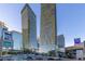 Street view of luxury high-rise buildings with retail shops below at 3722 Las Vegas Blvd # 2509, Las Vegas, NV 89158