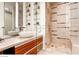 Bright bathroom with sleek vanity, modern glass shower, and open shelving for decor and storage at 3726 Las Vegas Blvd # 3202, Las Vegas, NV 89158