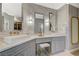 Elegant bathroom featuring double sinks, vanity with makeup stool, and marble tile surround at 3728 Richard Allen Ct, Las Vegas, NV 89147